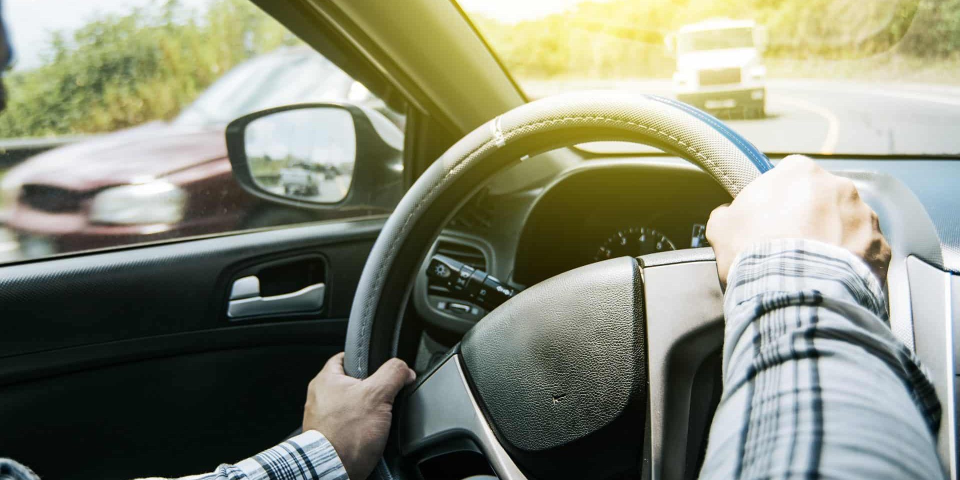 Close up of man's hands on the wheel, a person driving with hands on the wheel, A man with hands on the wheel of the car, Concept of hands on the wheel of a car