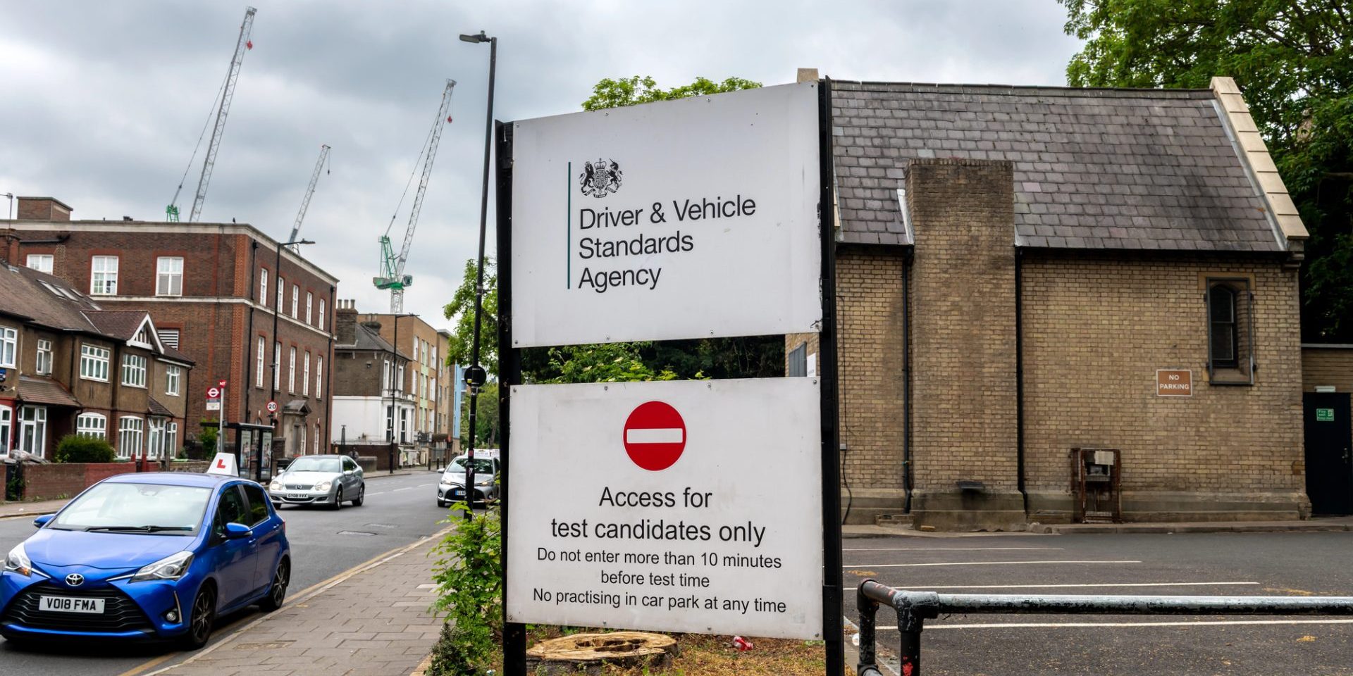 London. UK- May 04. 2026. The Driver and Vehicle Standards Agency sign by the entrance to a driving test centre with the building in the background. — Photo by MingPhoto