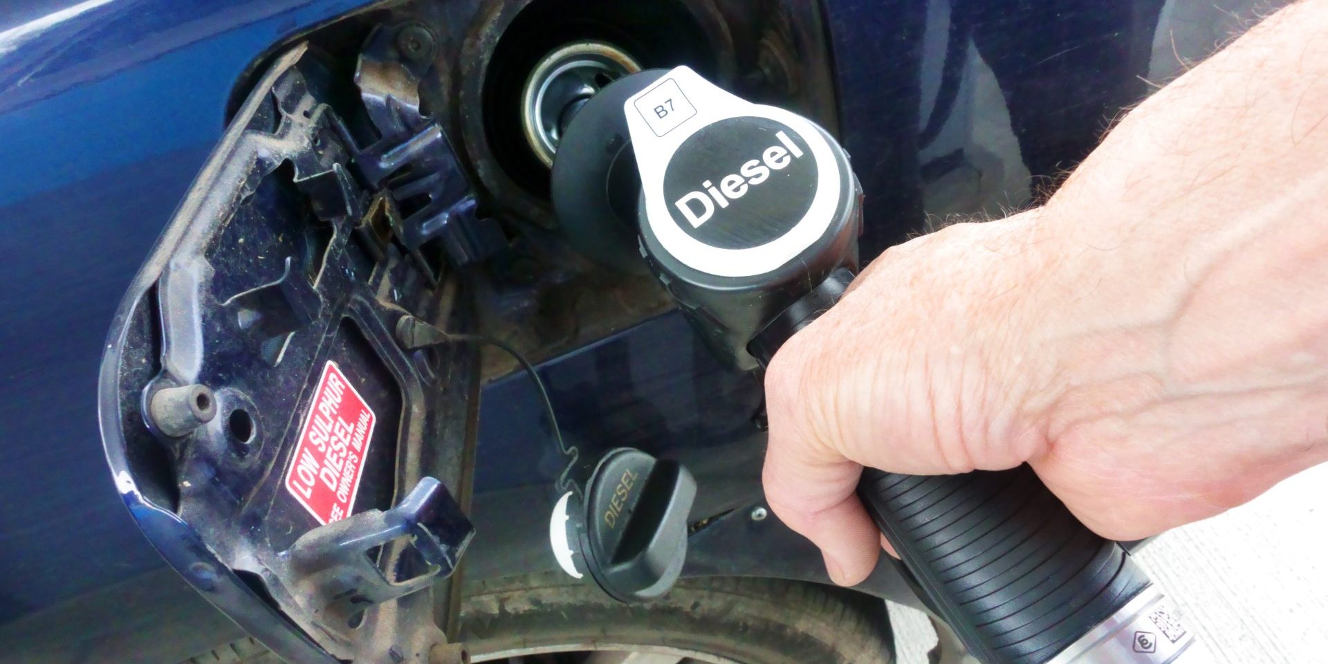 Diesel being pumped into car at petrol station