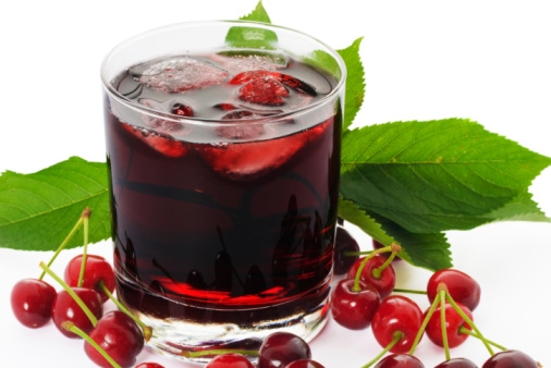 A refreshing glass of cherry juice with ice, promoting health and wellness.