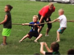 A group of children engaging in a lively game of tug-of-war to promote health and wellness.