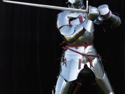 A knight in armor performing manual therapy with a sword for pain relief.