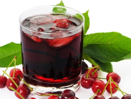 A refreshing glass of cherry juice with ice, promoting health and wellness.