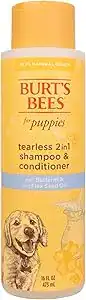 Burt’s Bees Tearless 2-in-1 Shampoo & Conditioner for puppies in a yellow bottle, a gentle pet grooming essential made with buttermilk and flaxseed oil.