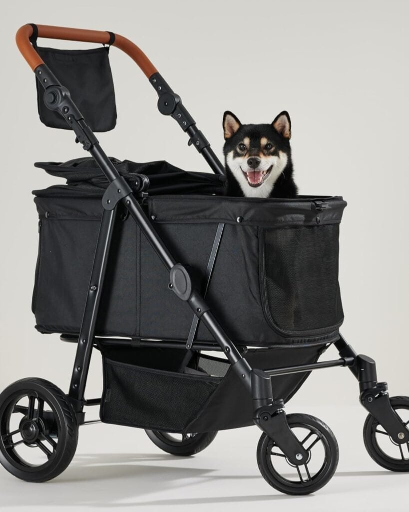 Larage black dog sitting comfortably in a heavy-duty dog stroller with mesh sides and large wheels, ideal for senior dogs and large breeds.