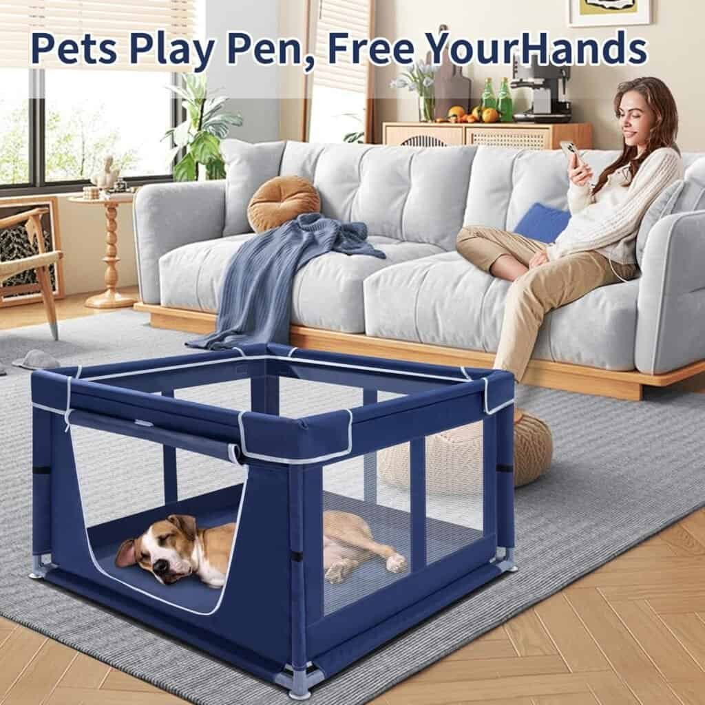 Blue soft-sided playpen for dog shown in a living room, with a small dog resting inside and a woman sitting on the couch nearby, demonstrating a safe indoor containment space.