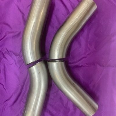 Polished stainless steel exhaust pipes for vehicle mufflers.