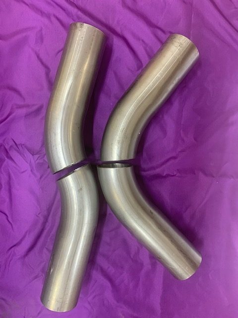 Polished stainless steel exhaust pipes for vehicle mufflers.