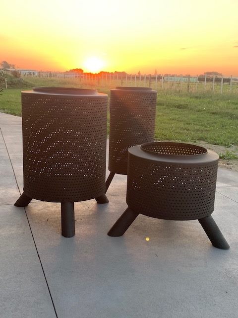 Stylish black perforated fire pits with three legs for outdoor heating and ambience. Perfect for patios and gardens in NZ.