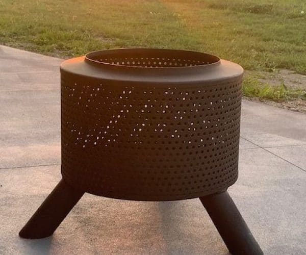 Heavy-duty perforated steel fire pit for outdoor heating and gatherings. Perfect for backyard, camping, or outdoor living spaces.