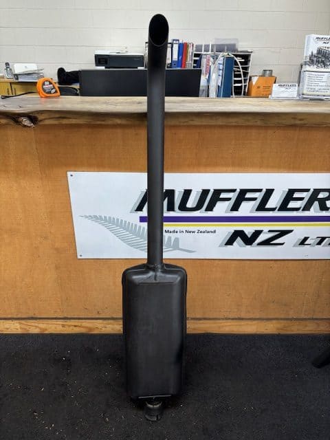 Stainless steel exhaust muffler on a trolley for vehicle repairs and upgrades.