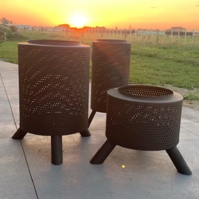 Perforated metal fire pits with tripod legs for outdoor heating and ambiance.