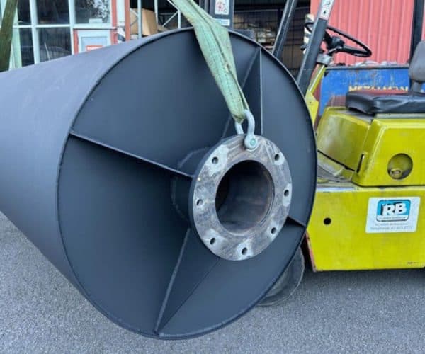 Heavy-duty muffler being transported on a forklift at Mufflers NZ Ltd. specialist exhaust and muffler shop.