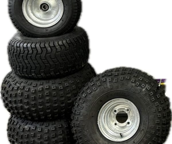Stacked off-road vehicle tyres with metal rims for durability and traction.