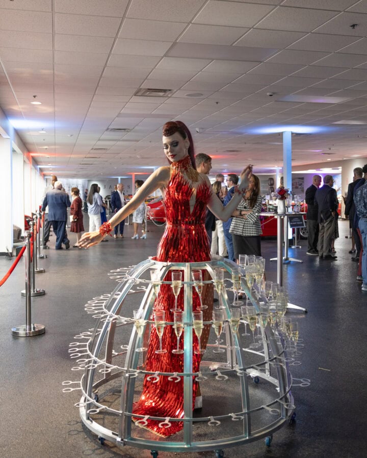 Lady with skirt made of champagne glasses