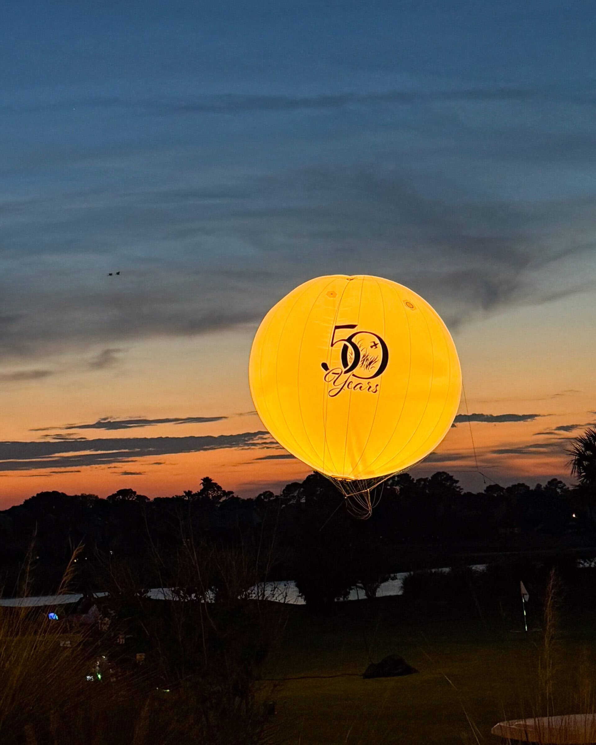 floating orb displaying the club’s 50th-anniversary logo