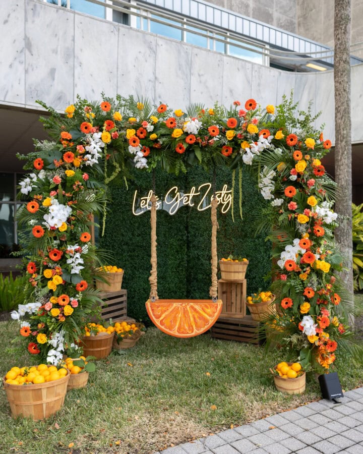 Orange Swing at an event with a sign that say Let's get Zesty