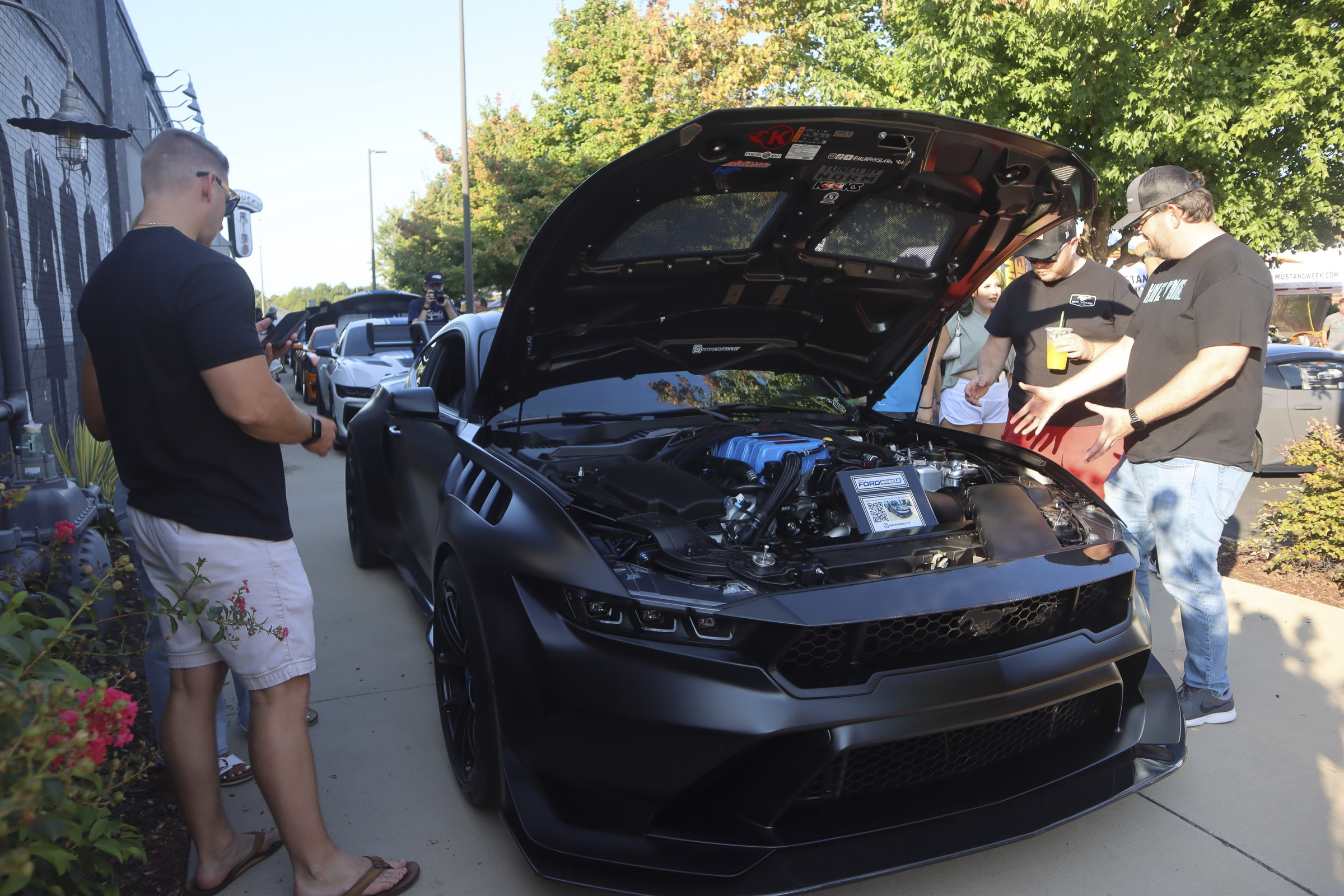 Black Ford Mustang with open hood at Mustang Week event in Charlotte 2026.
