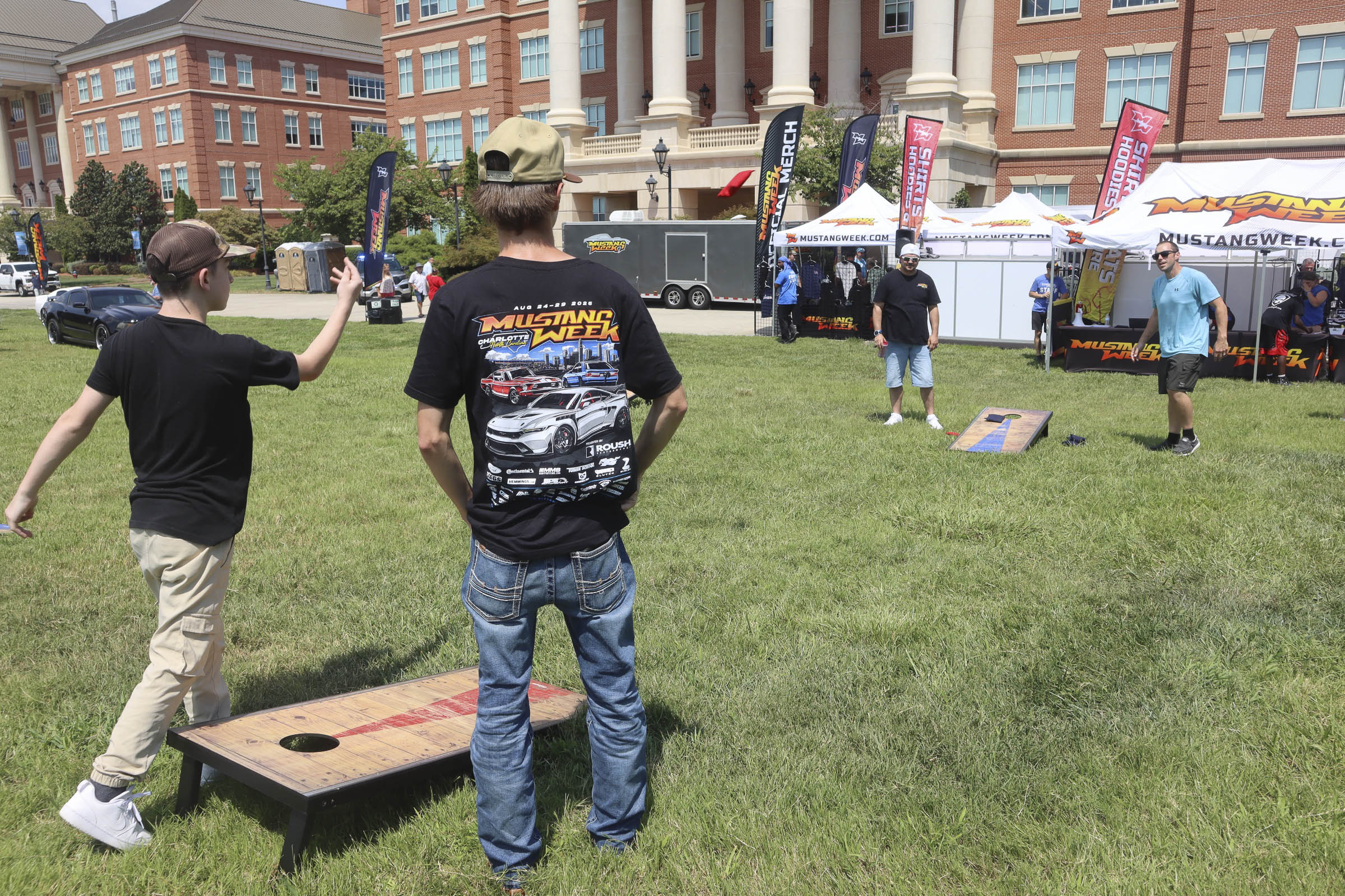 People playing cornhole at Mustang Week outdoor event in Charlotte 2026.