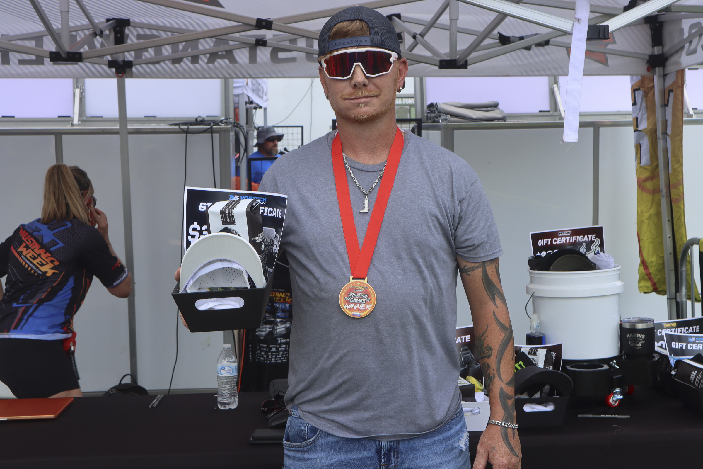 Man with medal at Mustang Week car event in Charlotte 2026.