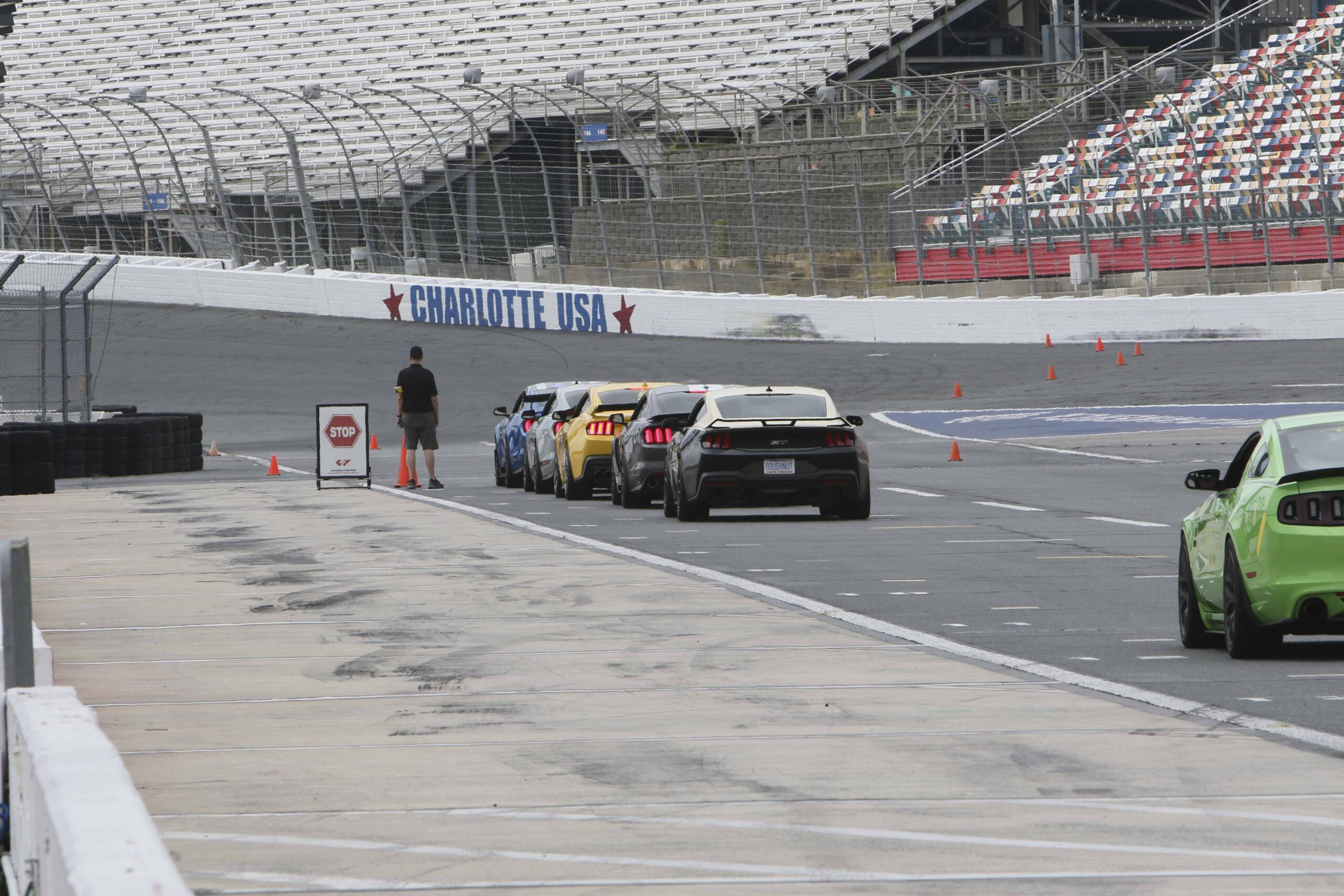 Line of high-performance Ford Mustangs on the race track at Charlotte.
