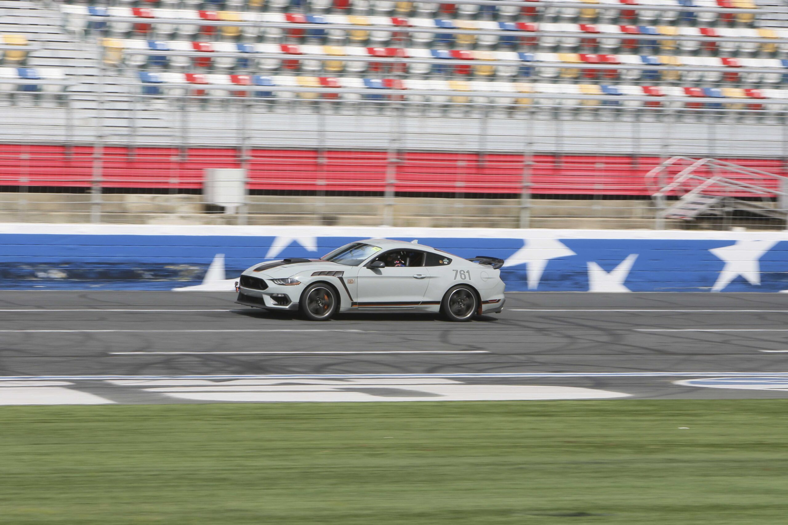 Silver Mustang race car on track at Charlotte 2026 event.