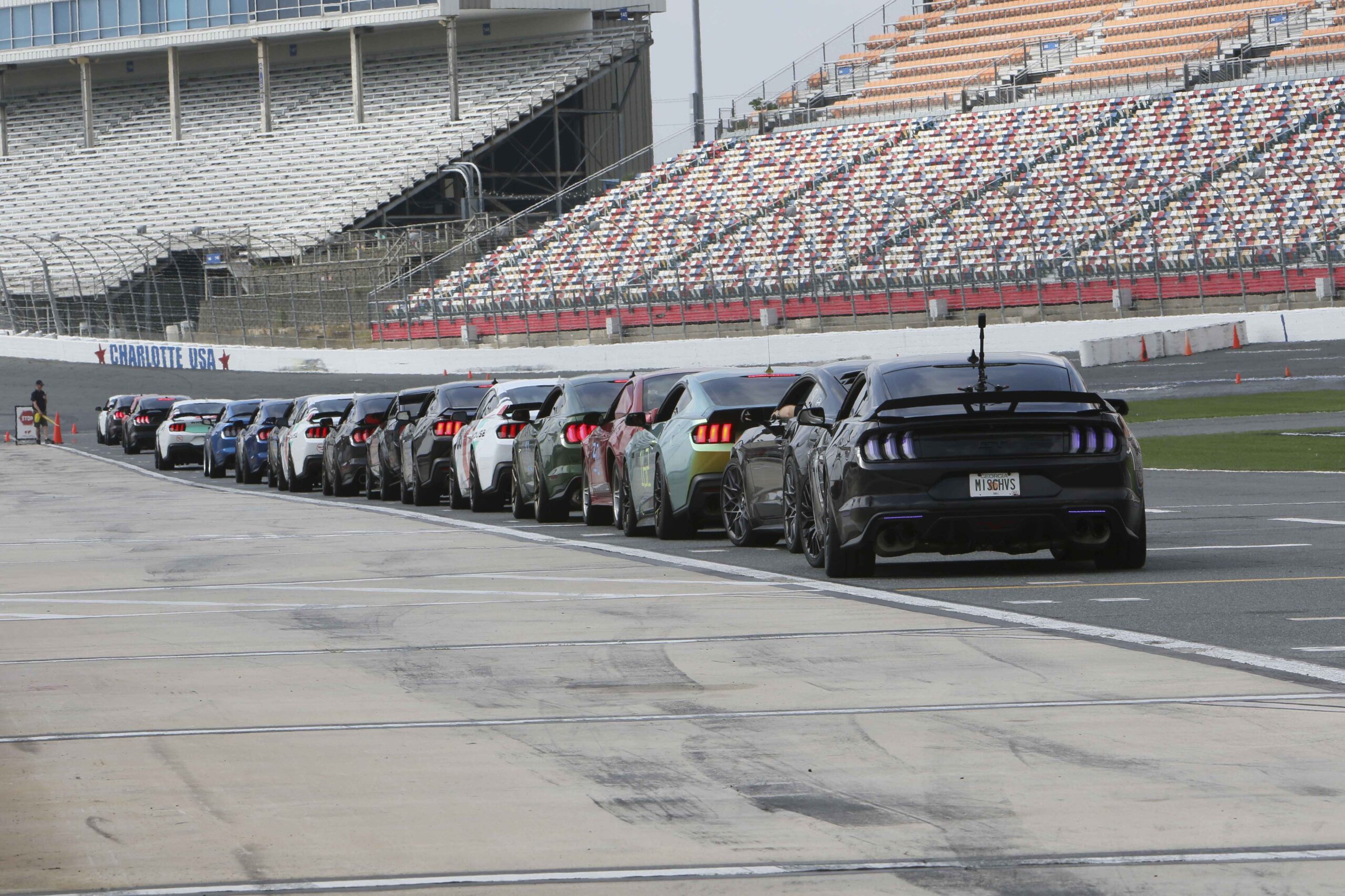 Lineup of Ford Mustangs at Charlotte Motor Speedway during Mustang Week.