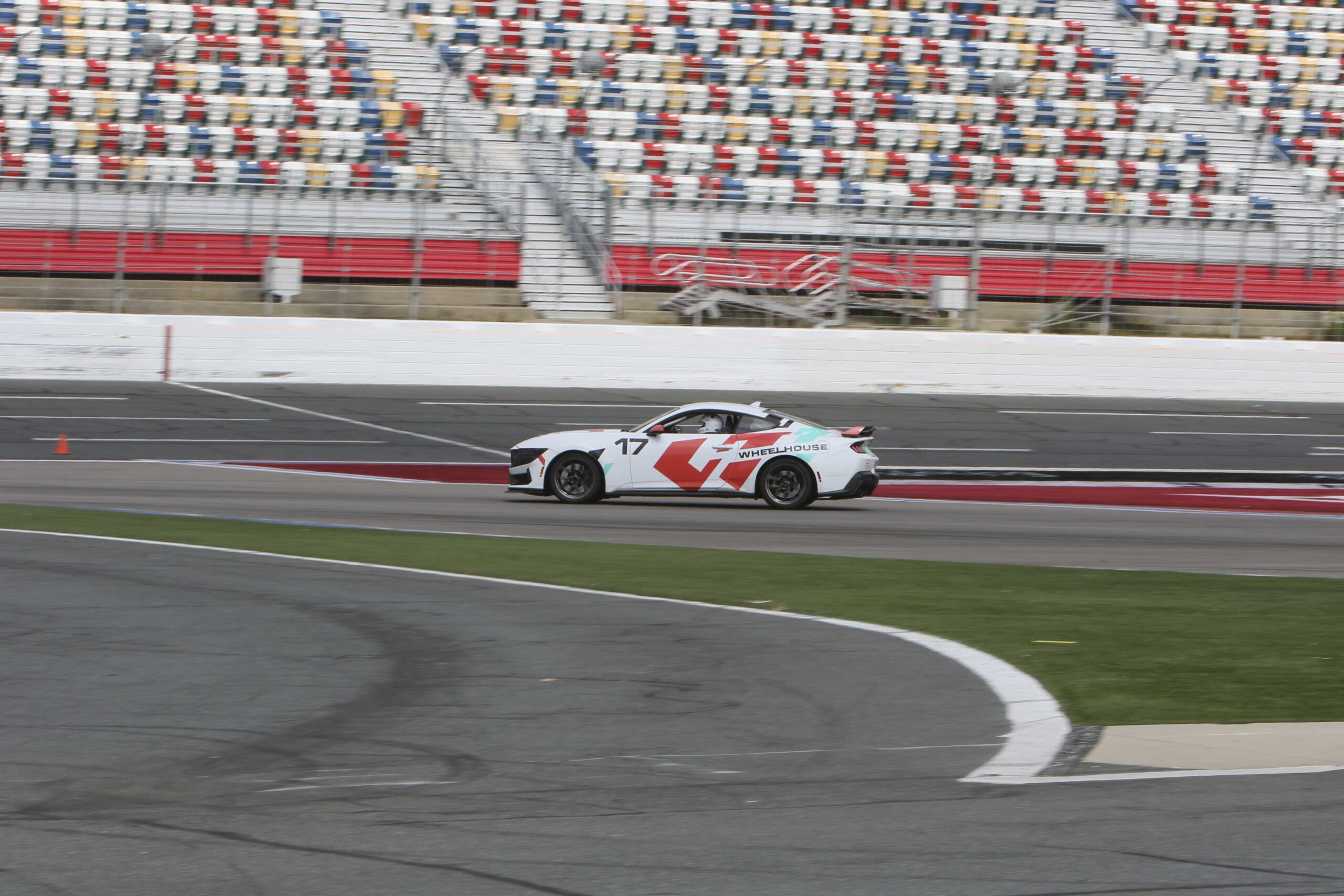 Race car on track during Mustang Week at Charlotte 2026 event.