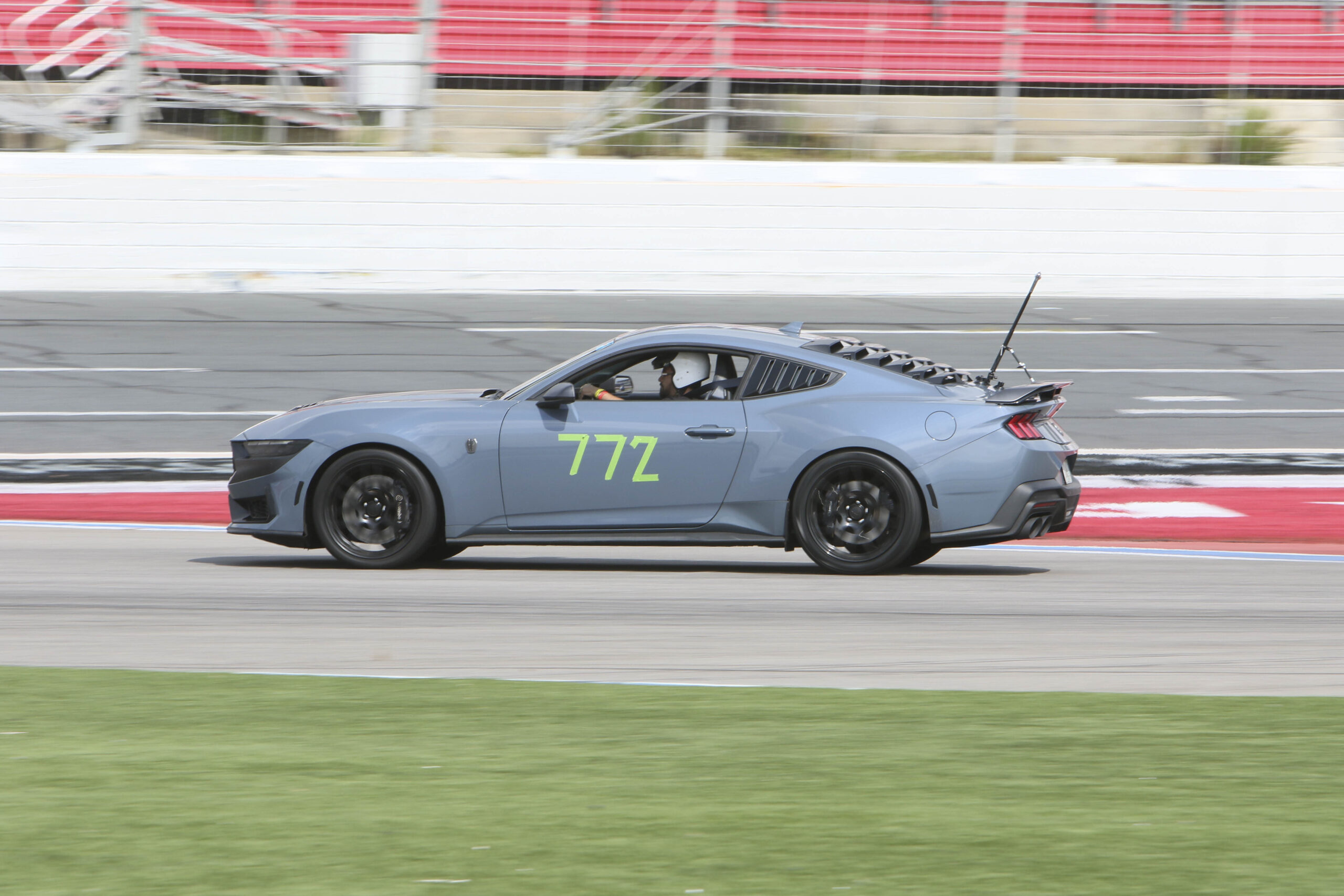 Race car with number 772 on track during Mustang Week event.