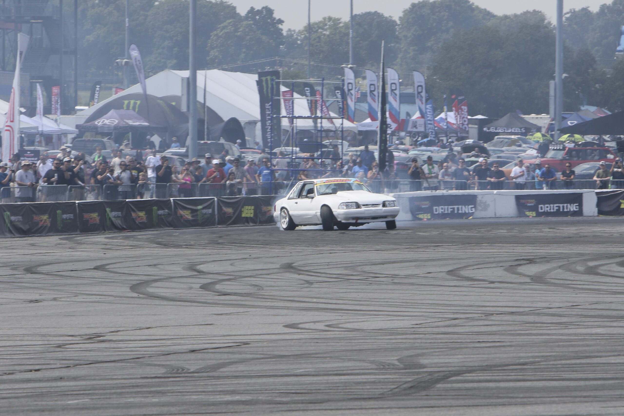 White drift car performing at Mustang Week event in Charlotte 2026.