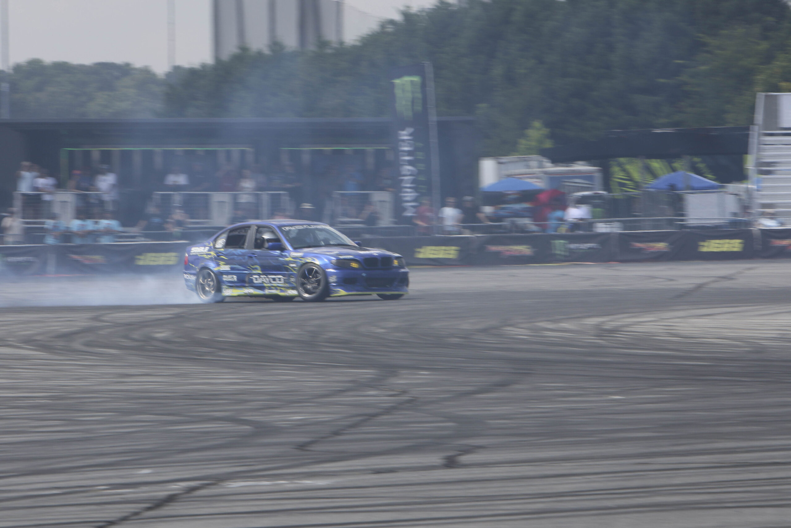Drift car performing a burnout at Mustang Week event.