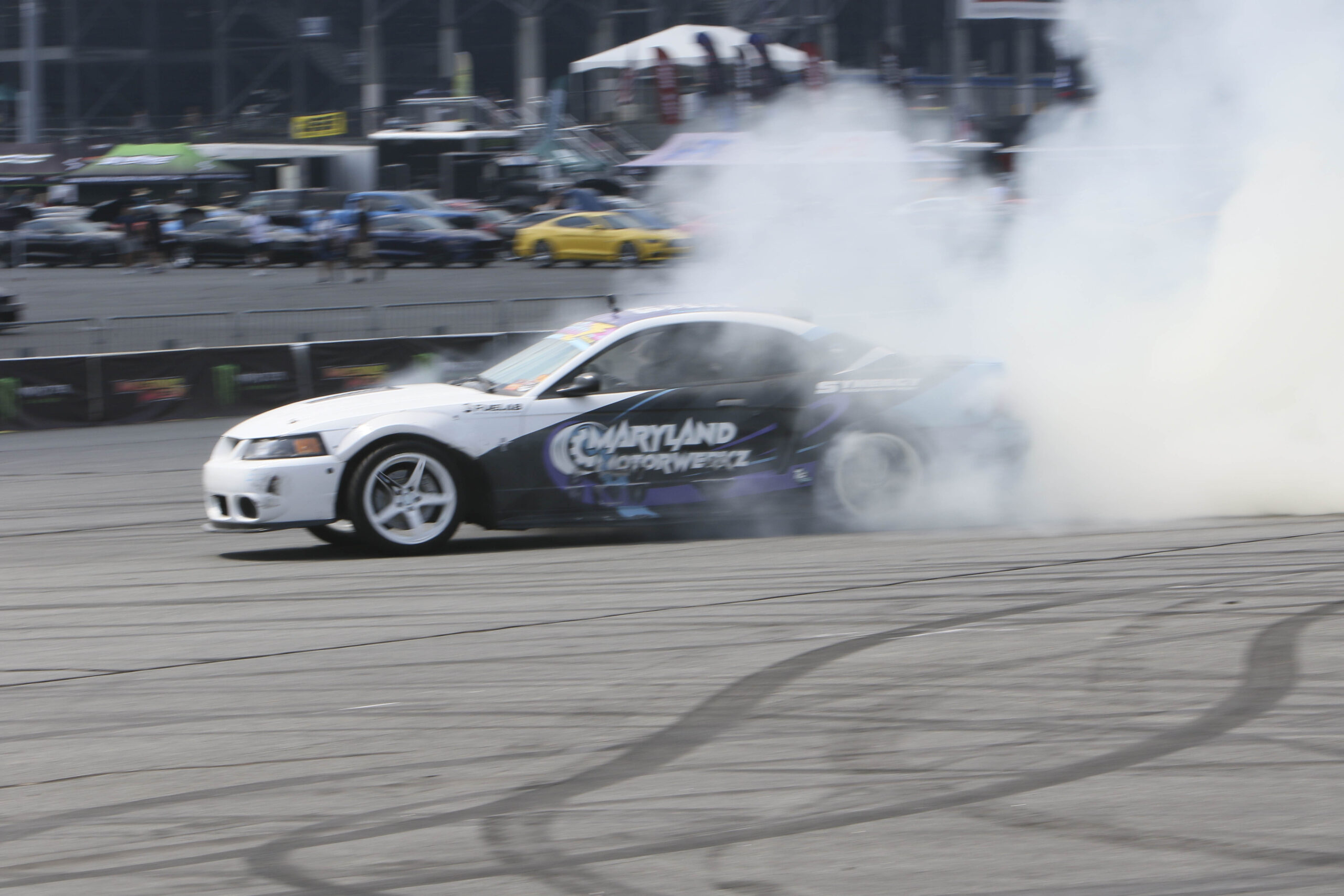 Drift car performing burnout at Mustang Week event in Charlotte 2026.