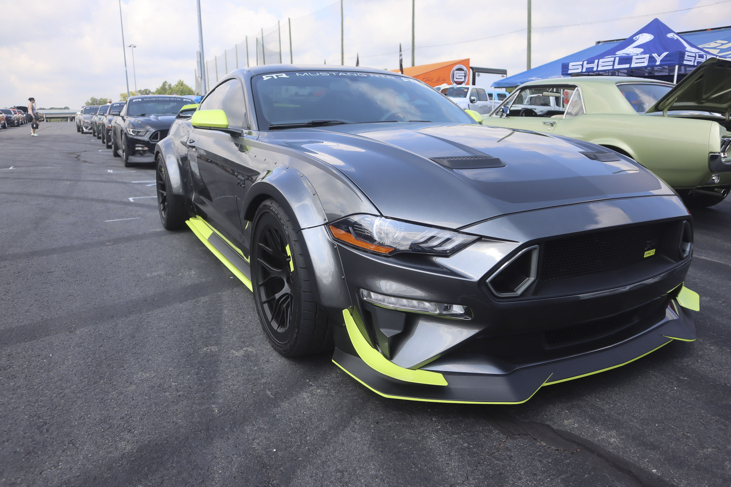 Black and neon green custom Ford Mustang at Mustang Week event.
