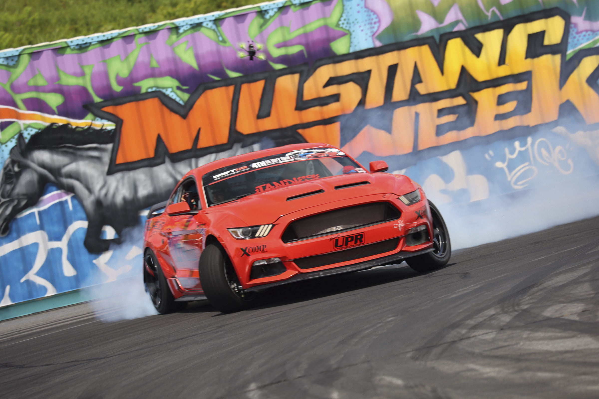 Red Ford Mustang drifting at Mustang Week event in Charlotte 2026.
