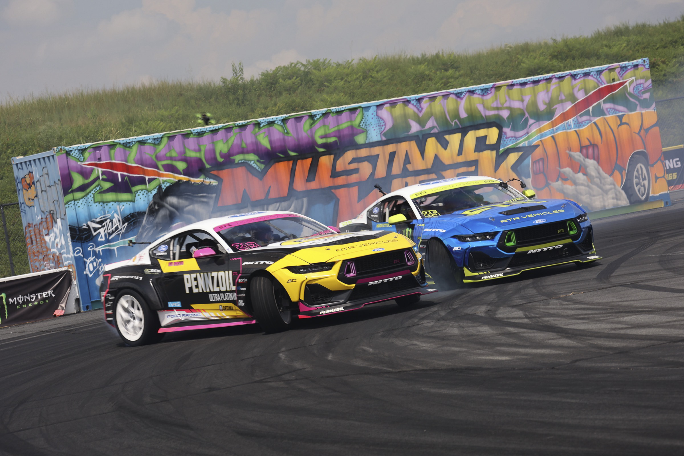 Two race cars competing at Mustang Week Charlotte 2026 event.