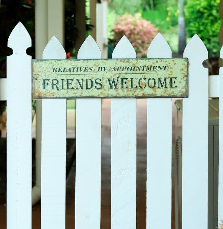a white picket fence with a sign that says relatives by appointment friends welcome