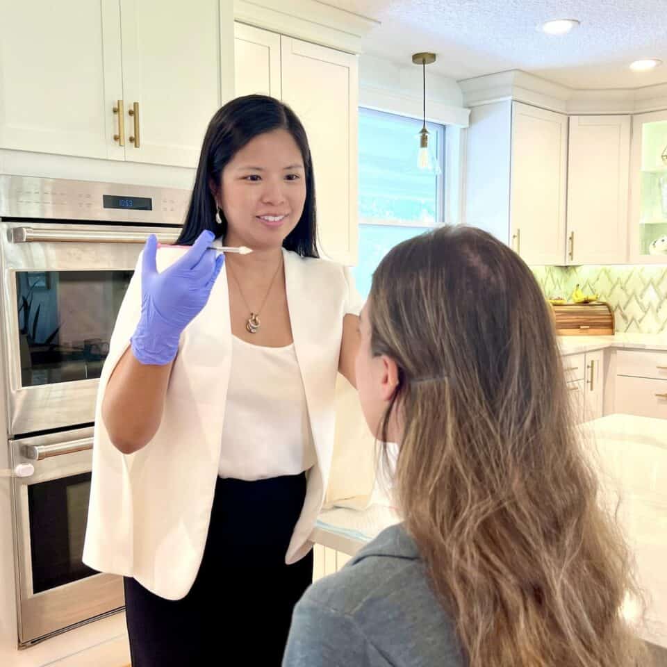 4 people standing around a net holding their pickleball racket