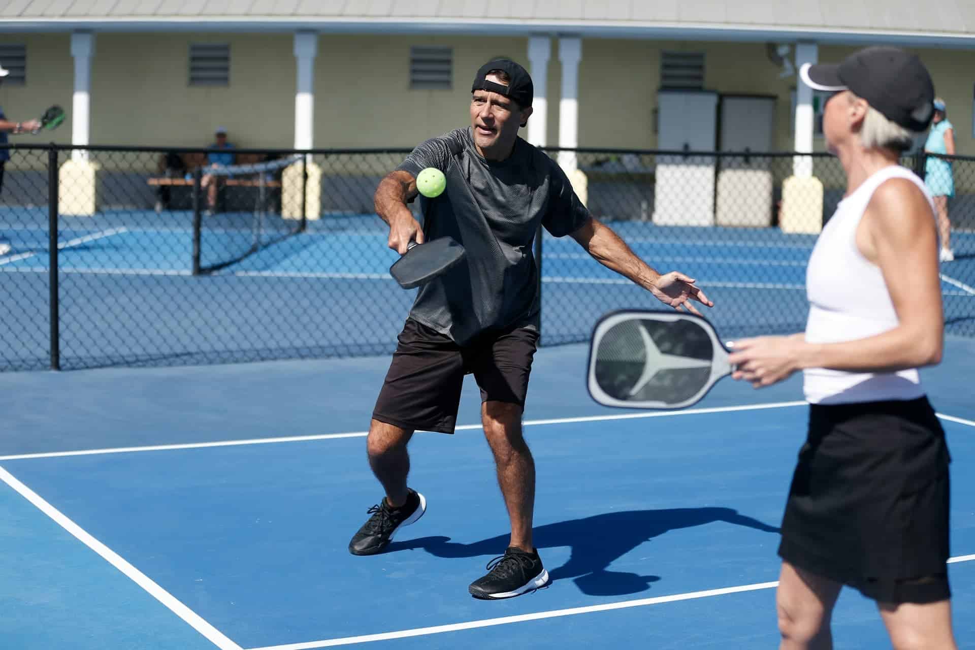 2 people playing pickle ball