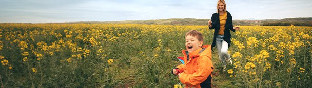 Meridian Trust Federal Credit Union logo with a family outdoors in a yellow flower field.
