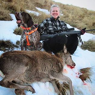 Me with a rifle on a hill with a shot deer and my german shorthair pointer dog