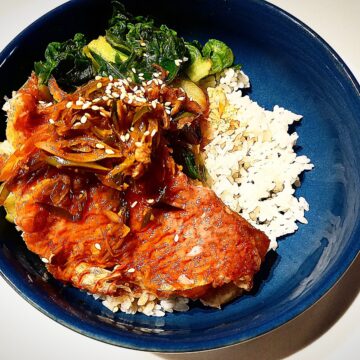 Pan fried scarlette wrasse with xo sauce, steamed rice and asian greens in a blue bowl plate