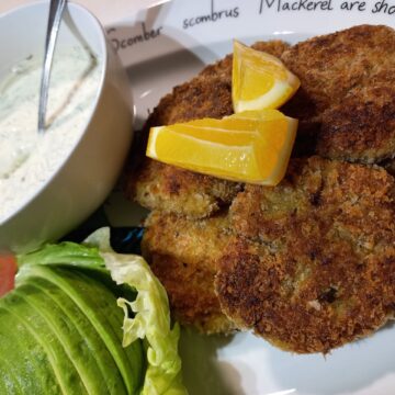 clam fritters, ranch dip, tomato, avocado and lettuce on the side and two lemon edges on top