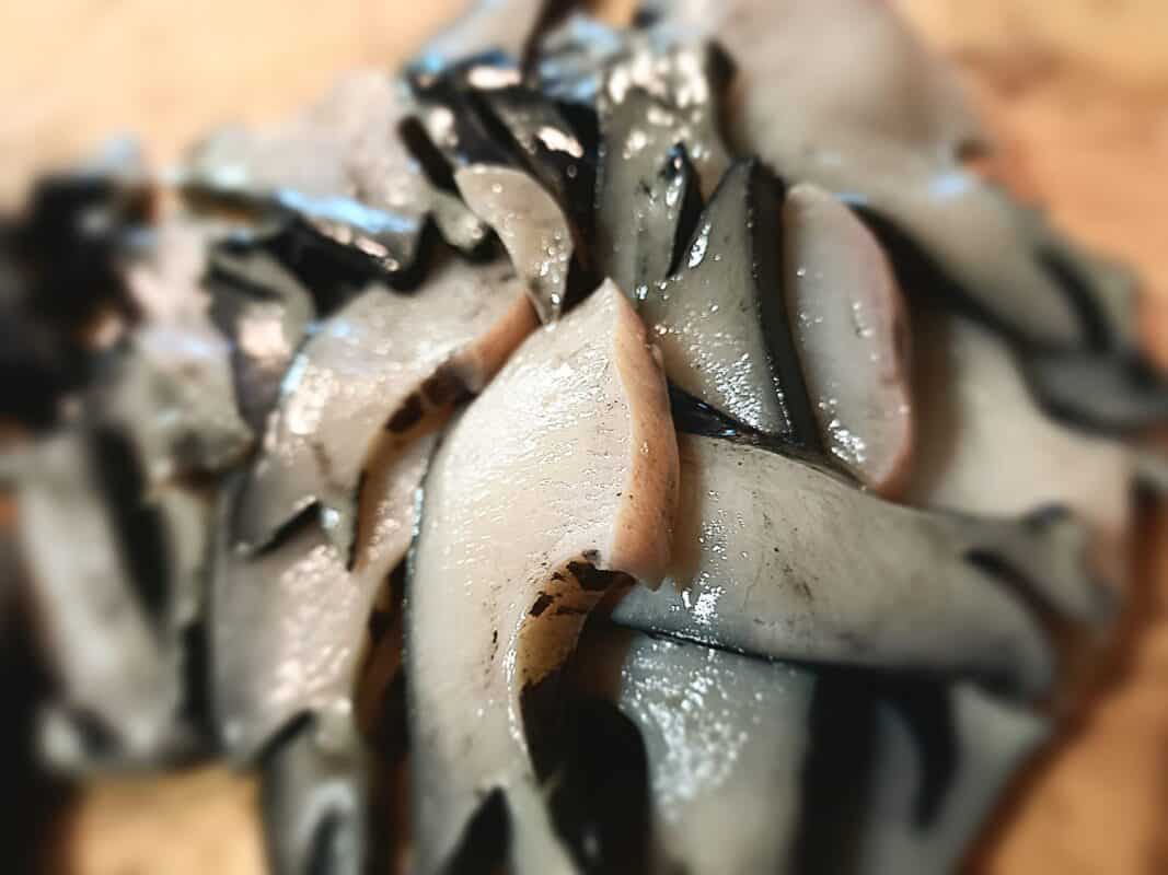 sliced paua on a chopping board