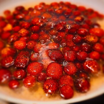 strawberry tree fruit covered with water in a saucepan