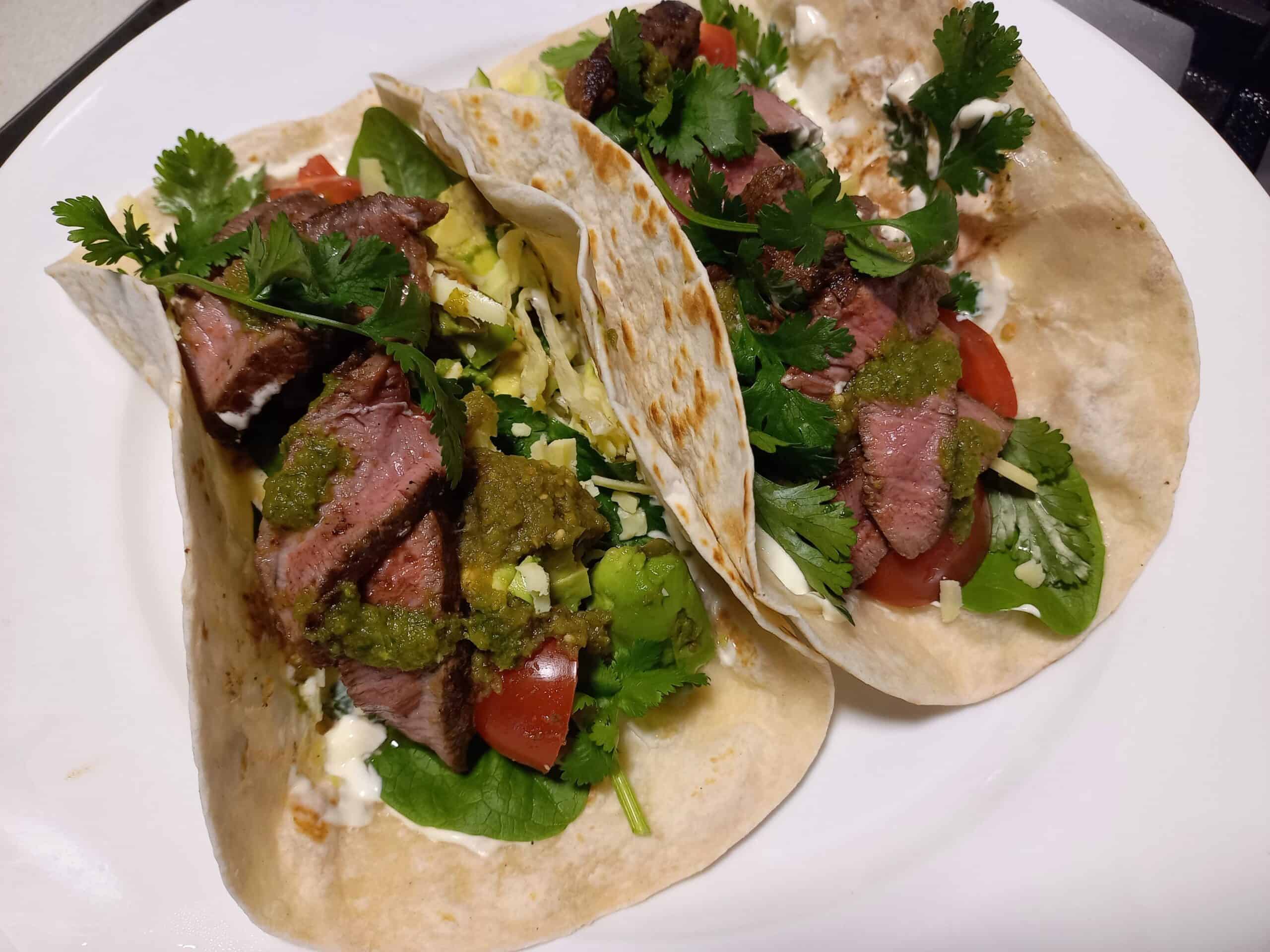 two venison soft shell tacos on a white plate