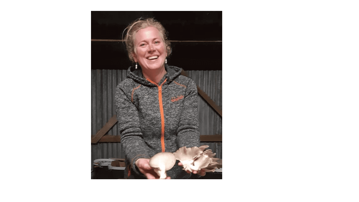 Me, a female holding homegrown oyster mushrooms in my hands