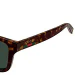 Stylish Gucci tortoise sunglasses with dark lenses, perfect for fashion and sun protection.