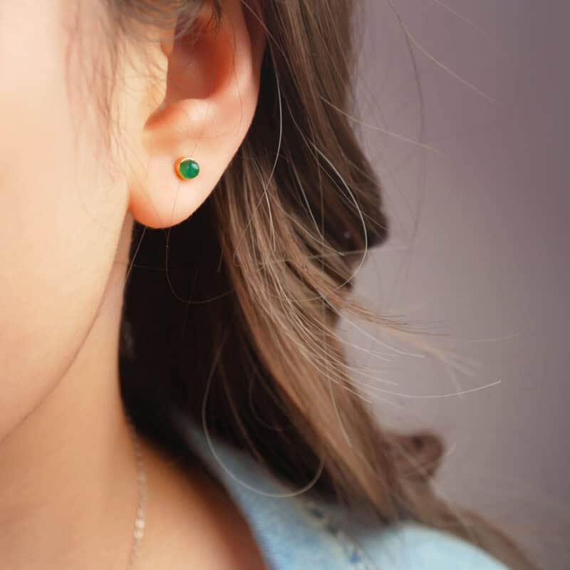 Model wearing the green agate mini studs, showing size and subtle sparkle