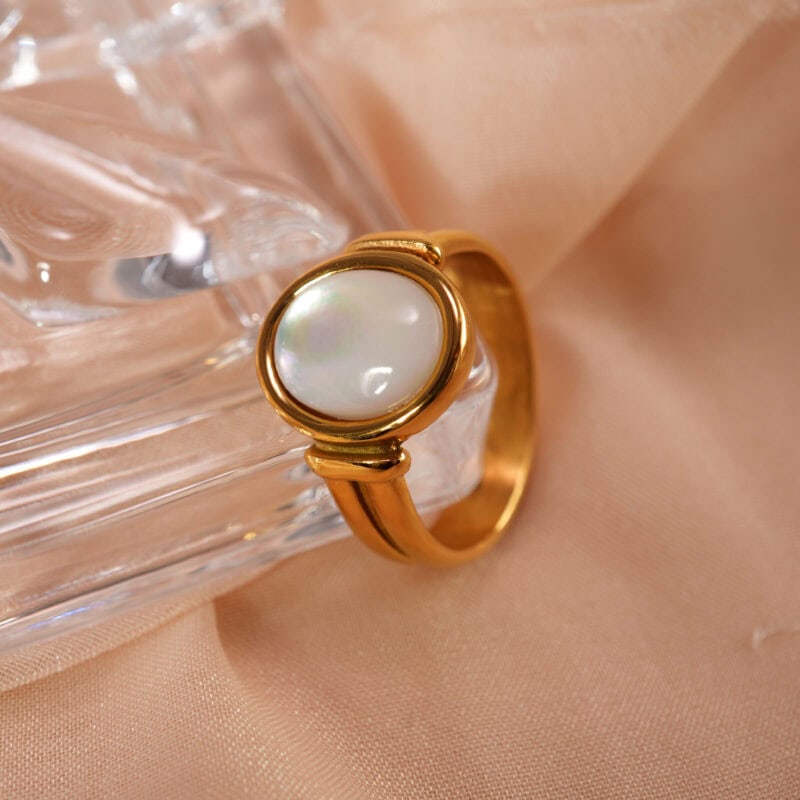 18k-gold-plated-ring-main.jpg" alt="18K Gold Plated Ring featuring an elegant oval shell design with polished gold finish, displayed upright on a light surface
