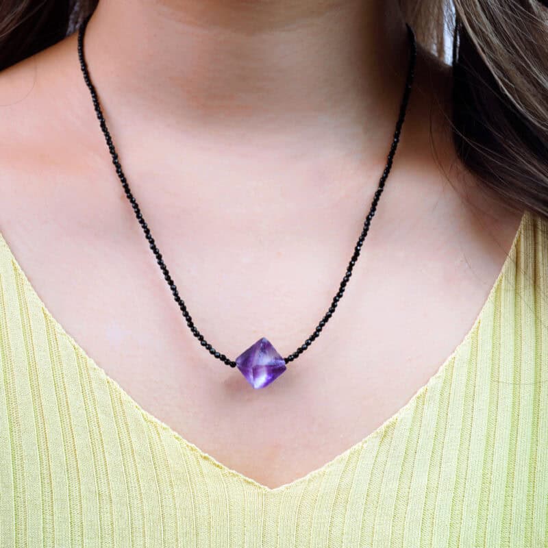 Model wearing the dainty necklace at the collarbone, showing lightweight elegance